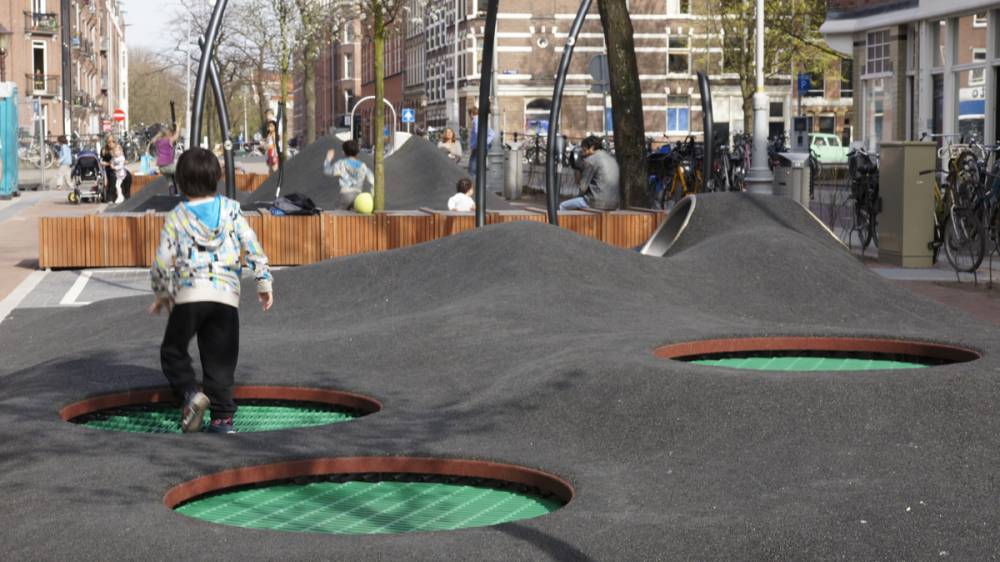 Recessed trampolines embedded in rubber surface