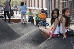 Two girls sit on rubber mounds