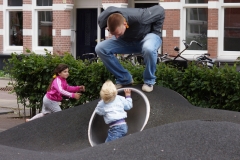 Small child and adult play among the mounds