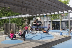 Children playing on tethered rope seats and rubber mounds