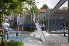 A metal slide lands between two poured rubber mounds