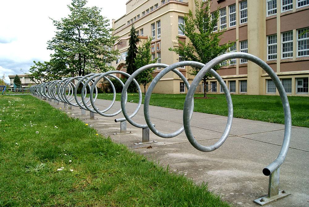 A long row of corkscrew bike racks can hold a lot of bikes