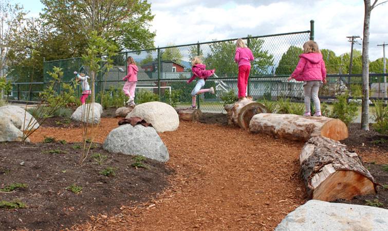Boulders double as play elements in this school garden
