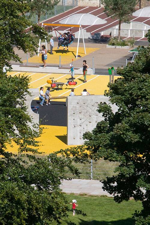 Striped concrete mounds add a fun element to this play environment