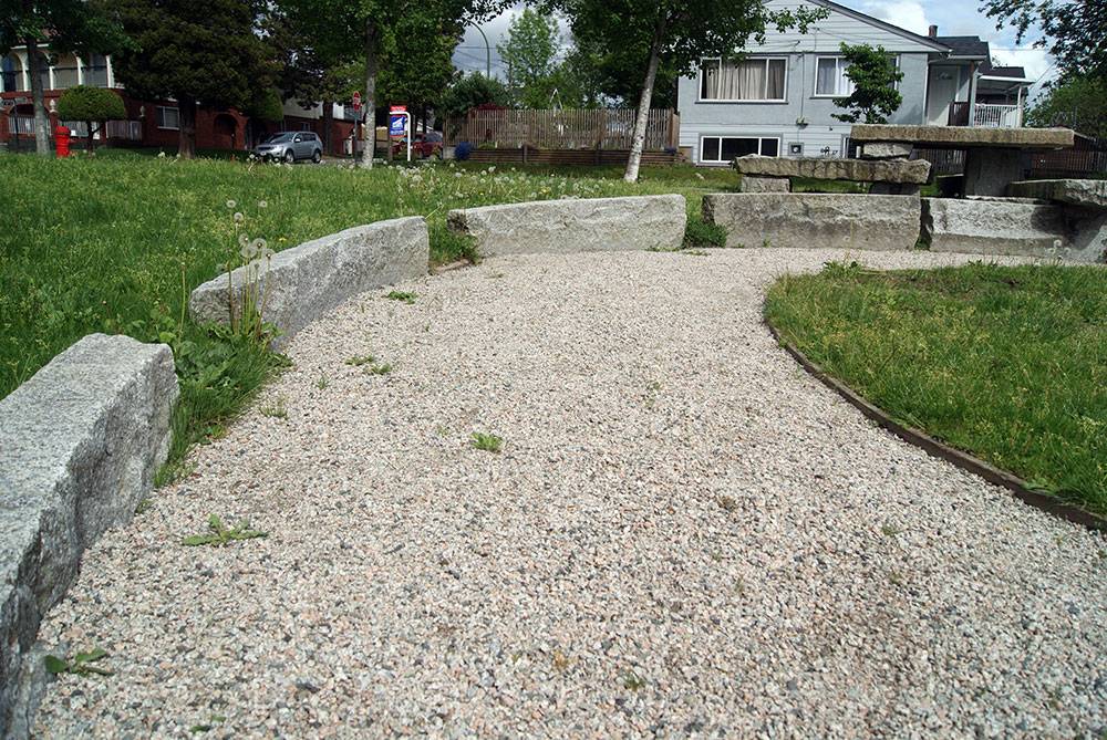 Gravel pathway edged with granite curb