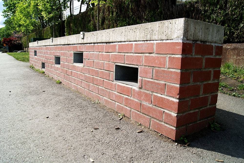 A freestanding wall with legacy bricks provides seating and an opportunity to recognize contributors