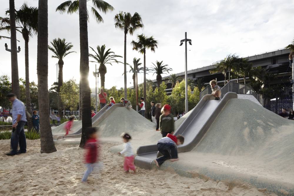 Slides embedded in poured rubber mounds provide plenty of play for young children