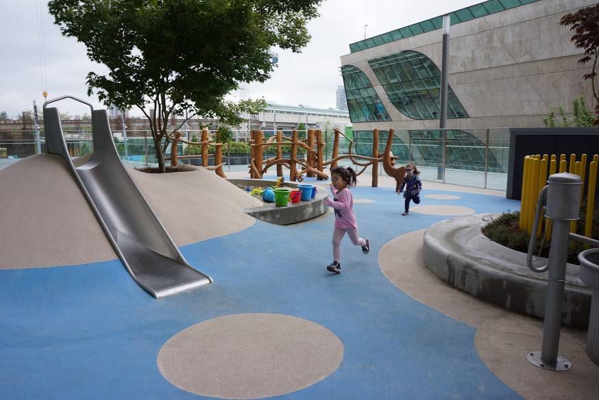 A slide for small children embedded in a rubber mound