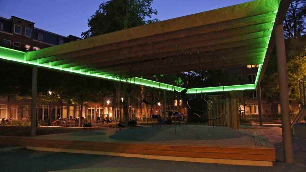 Bright green strips light up a play area at night