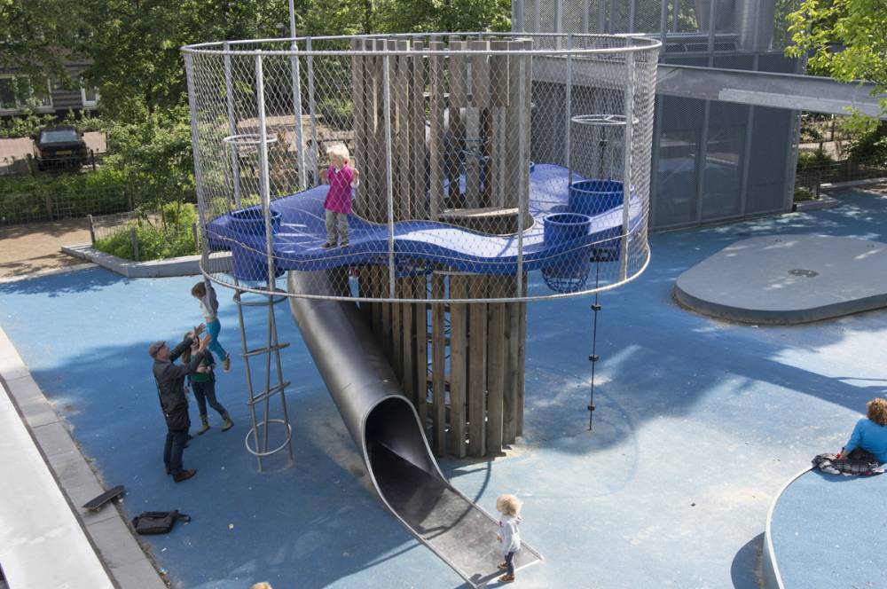 A chain link fence wall keeps kids playing on this tower safe