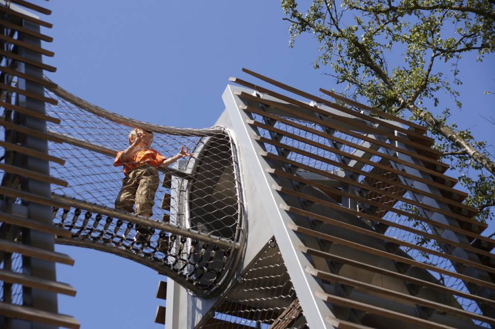 A fully enclosed rope bridge connects two play towers