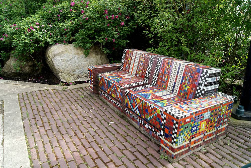 A fun couch-style bench sits over permeable brick paving
