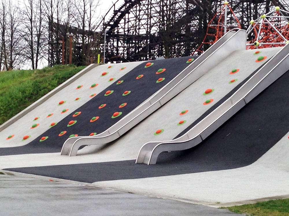 Climbing holds and slides on poured rubber slope