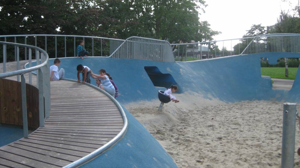 A wood surfaced ramp at an accessible playground