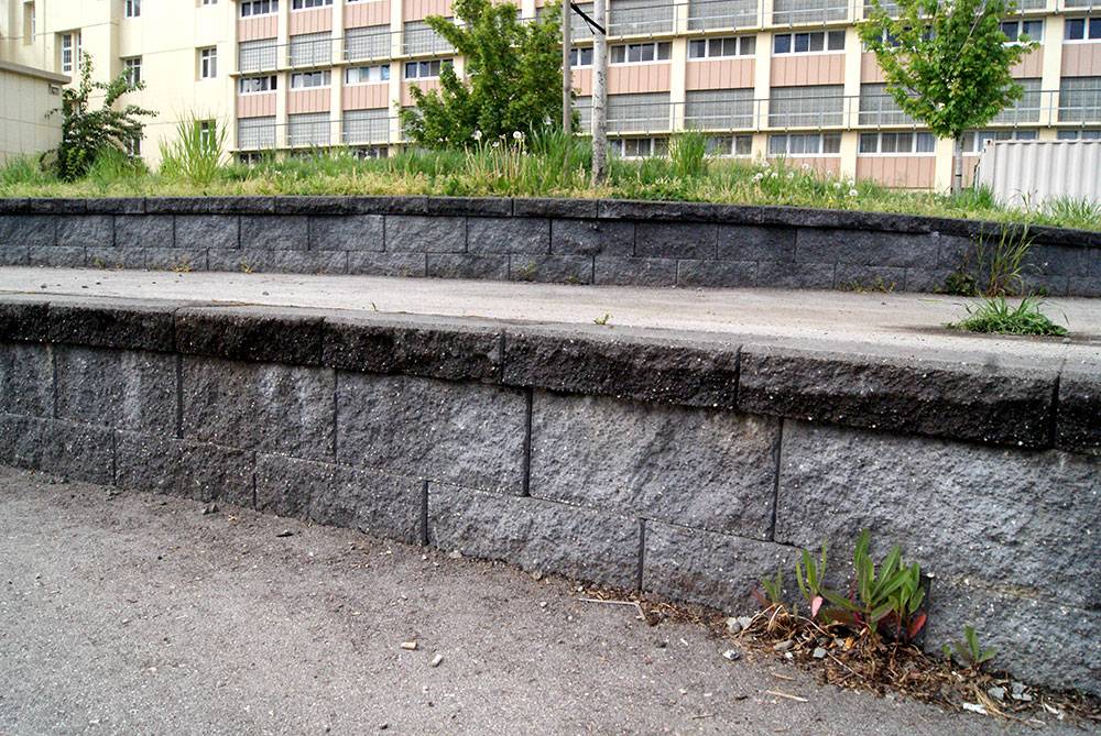 Rough concrete blocks look like stone in this retaining wall