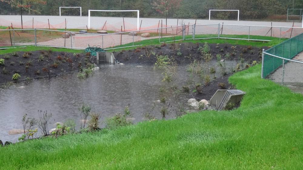 This retention pond fills with water on a rainy day - a chain link fence surrounds the water for safety