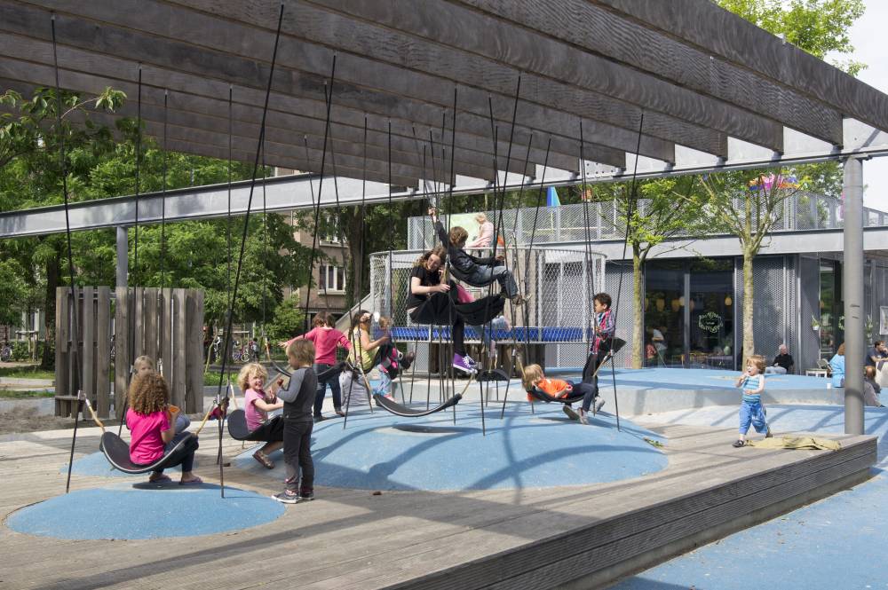 Monkey rope swings and seats attached to poured rubber mounds