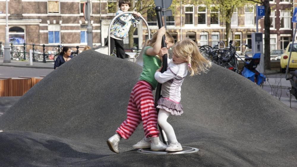 A spinning play element mounted on poured rubber