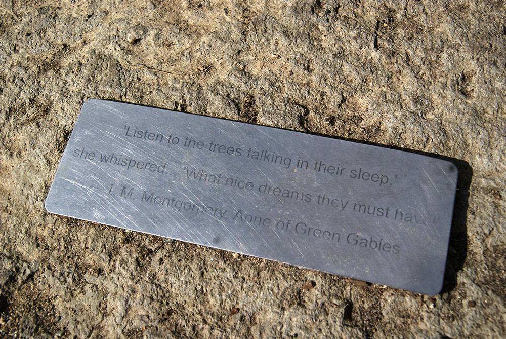 Small plaque on a boulder with literary quote