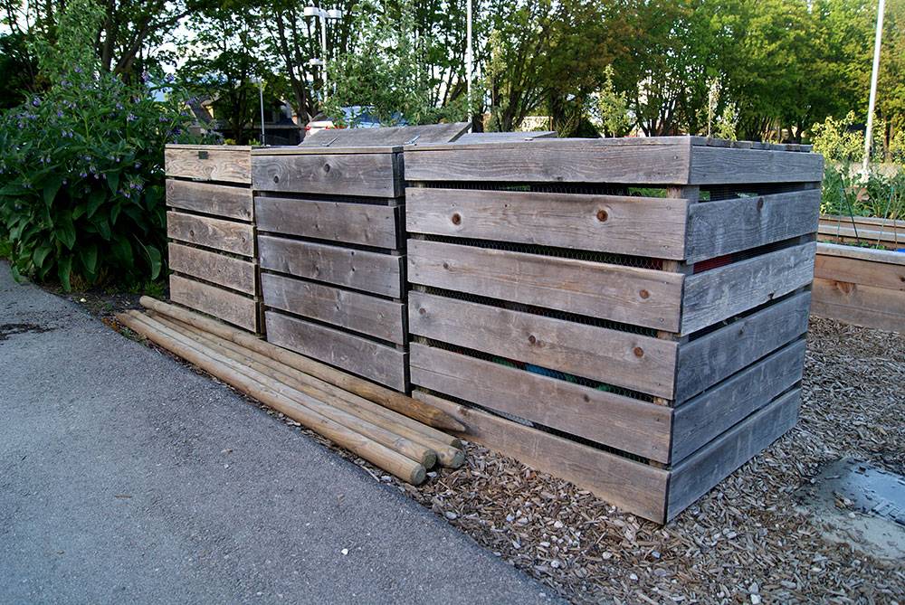 These bins match the wood of the raised planters for discreet storage