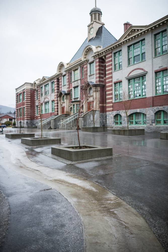 A concrete swale is embedded in asphalt at this elementary school