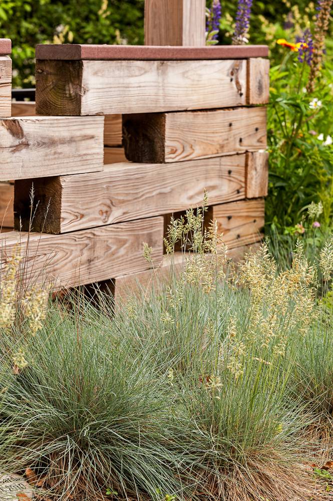 Grasses add an interesting visual element in front of this wood structure