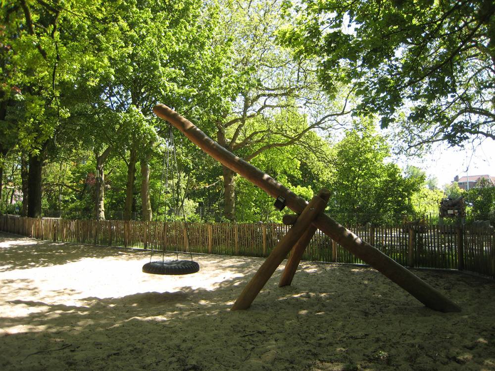 Tire swing suspended from logs in a Belgium Park