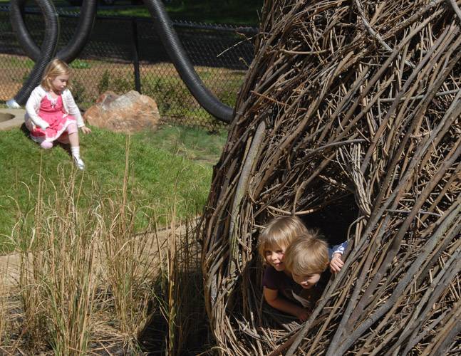 A natural play house constructed of woven branches