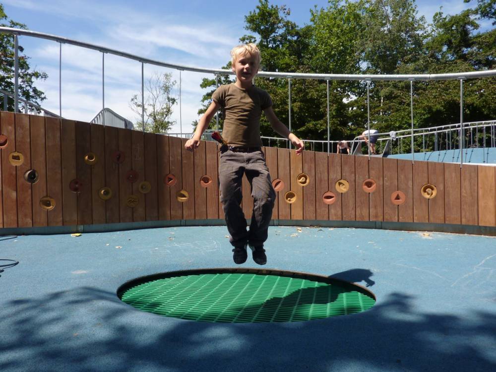 Jumping on a trampoline embedded in poured rubber