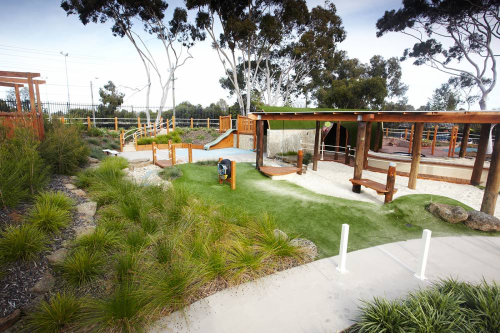 Native planting borders accessible concrete pathway