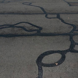 Repaired cracks in asphalt