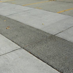 The lane slopes down to this strip of porous asphalt