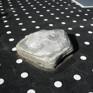 Rock embedded into painted asphalt