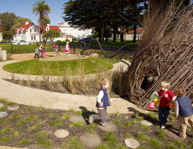 Overview of playground with natural and traditional play elements