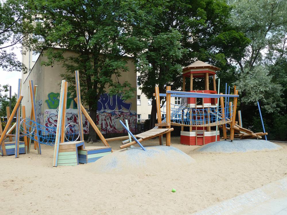 The climbing sequence winds through a series of poured rubber mounds and sand