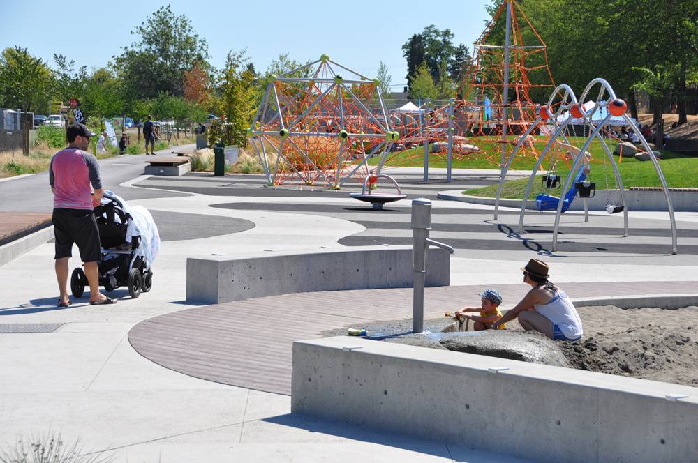 A sand pit with water play elements keeps small children entertained