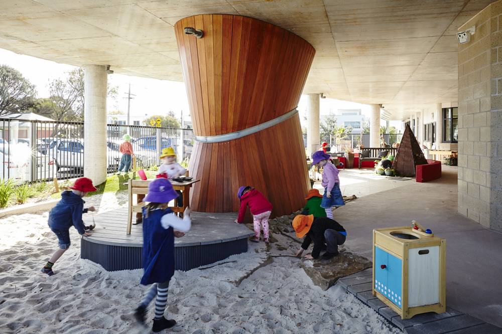 A small platform beside the sand play area (complete with a small sink to provide water)